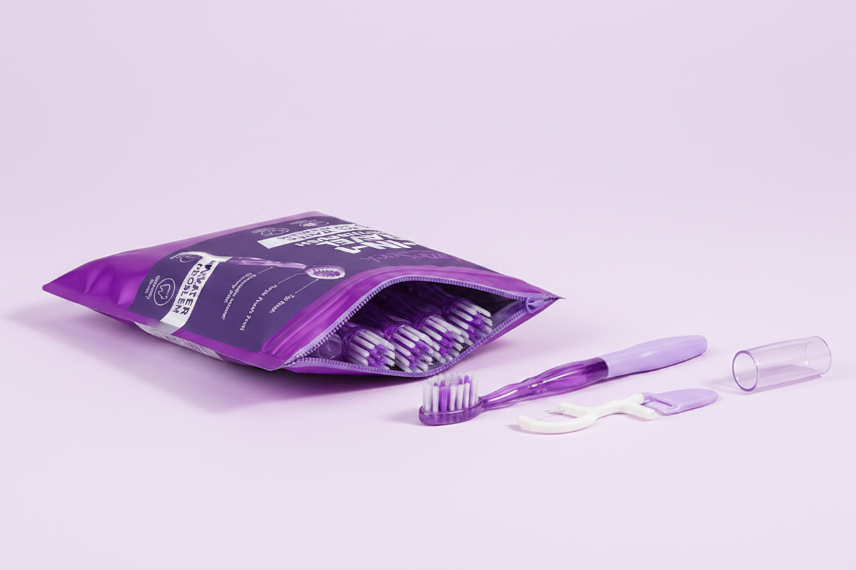 Open purple resealable travel toothbrush pouch with toothbrush and accessories arranged beside it